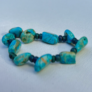 Asymmetrical turquoise beaded bracelet with tiny blue beads in between