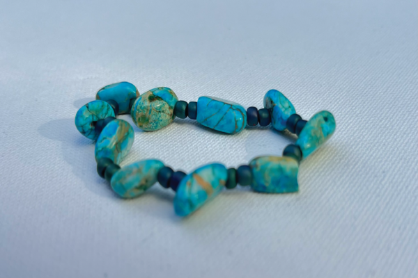 Asymmetrical turquoise beaded bracelet with tiny blue beads in between