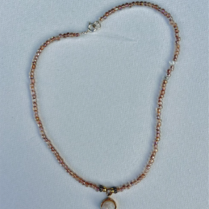 rose gold small beaded necklace with gold and white crystal pendant