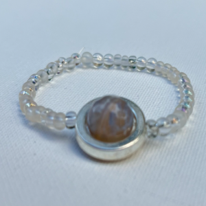 clear small beaded bracelet with silver and grey bead in center