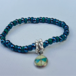 tiny green and blue beaded bracelet with silver divider beads and dragonfly charm