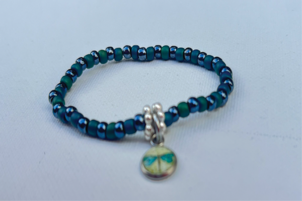 tiny green and blue beaded bracelet with silver divider beads and dragonfly charm