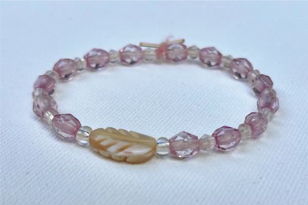 transparent lavender beads with palm leaf in center