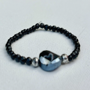 small black and silver beaded bracelet with larger iridescent black bead in center